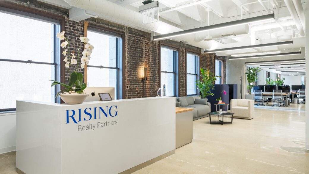 The new Rising Realty Partners' office looking from the reception entrance down towards the bullpen
