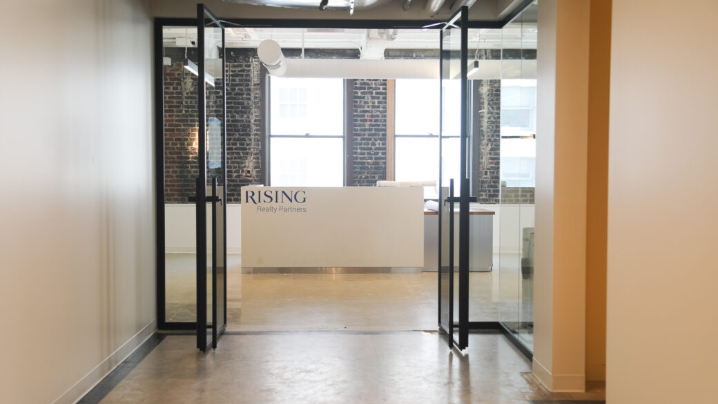 Photo of the Rising Realty Partners' office entrance reception desk from the hallway.