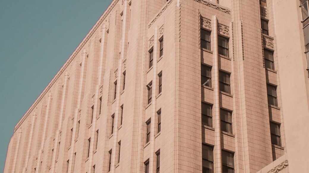 A modern view from the street looking up towards the top of The Trust Building.