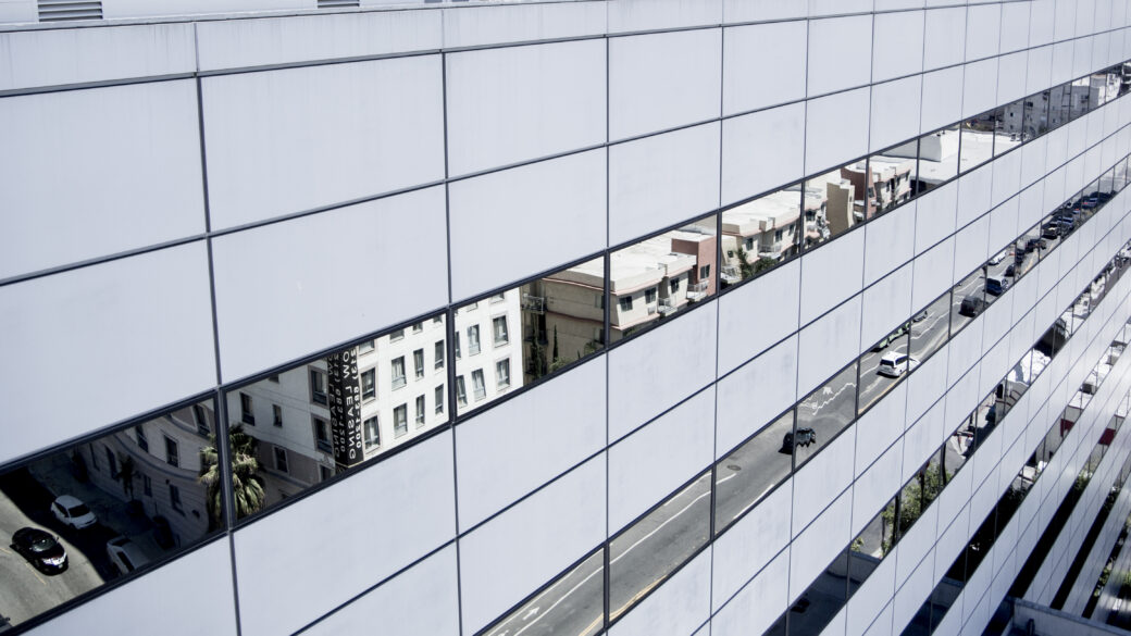 Exterior view of the Garland Center, a data center facility with reflections of neighbouring buildings in the windows.