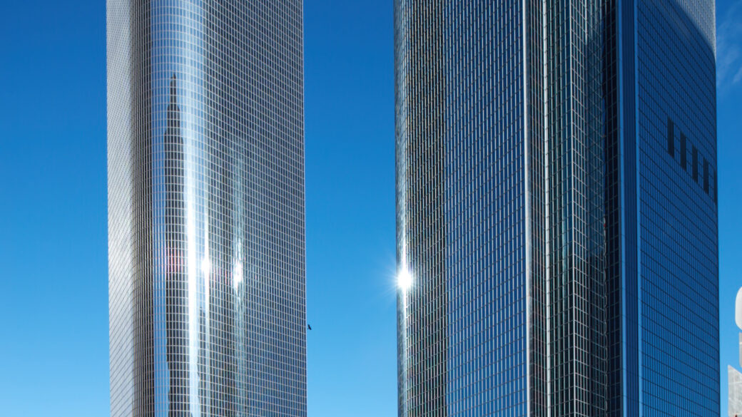 The beautiful 1 Cal Plaza stands against a bright city skyline, an iconic landmark that towers over the surrounding office buildings.