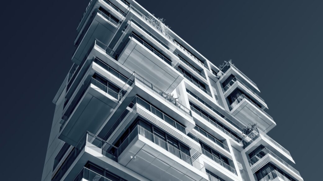 Photo looking up at a multi-family building with the sky in the background